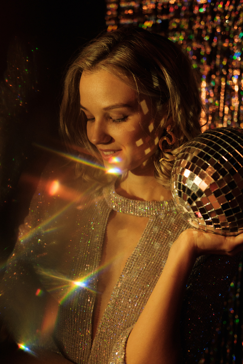 Woman Holding a Mirror Ball at a Party